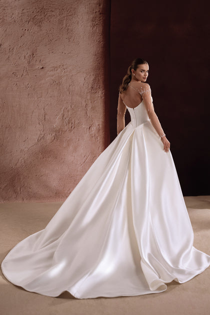 The Aylin bridal gown with satin buttons along the back showcases timeless detail and understated beauty.