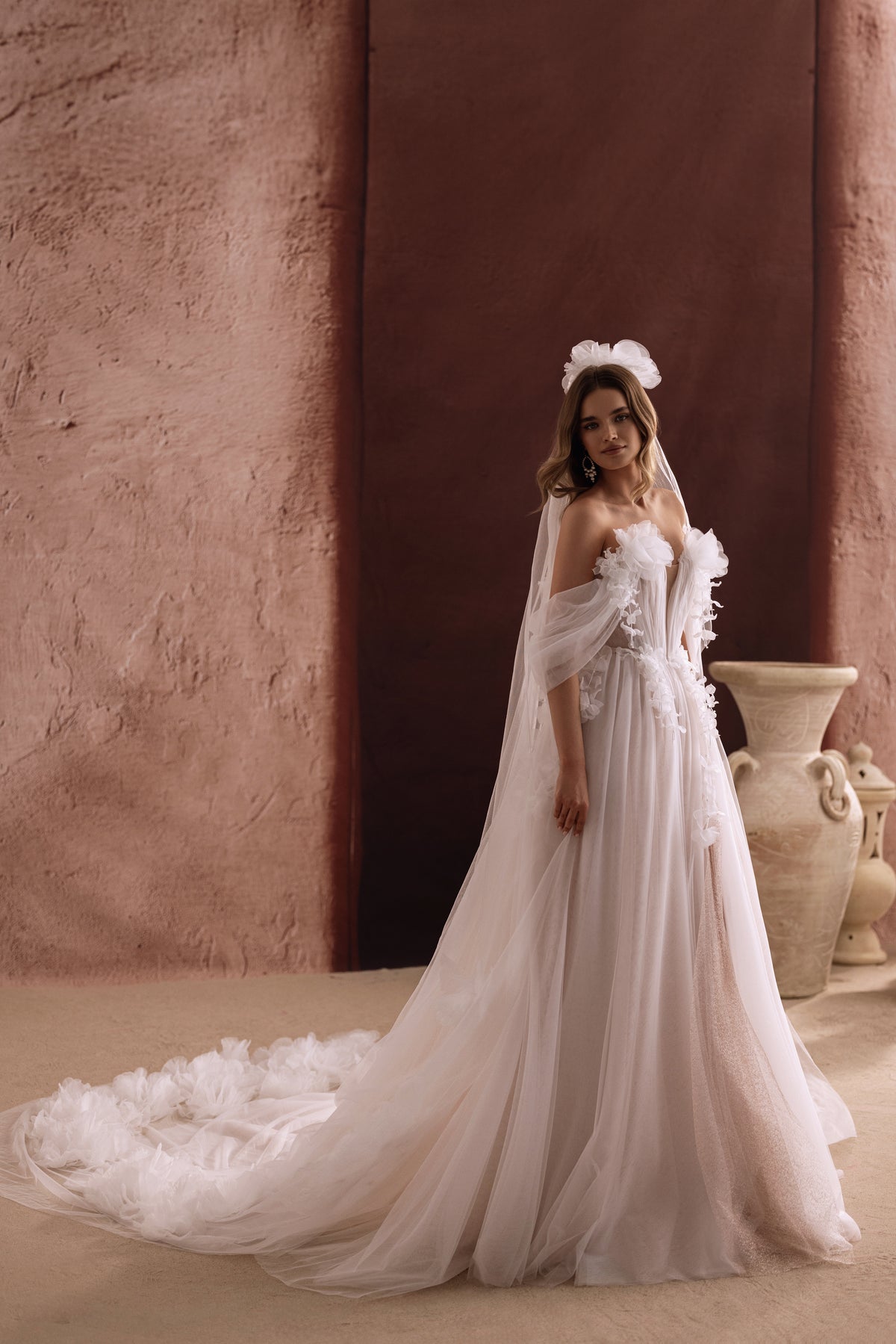 Bella wedding dress from behind, with 3D flowers scattered over its tulle train