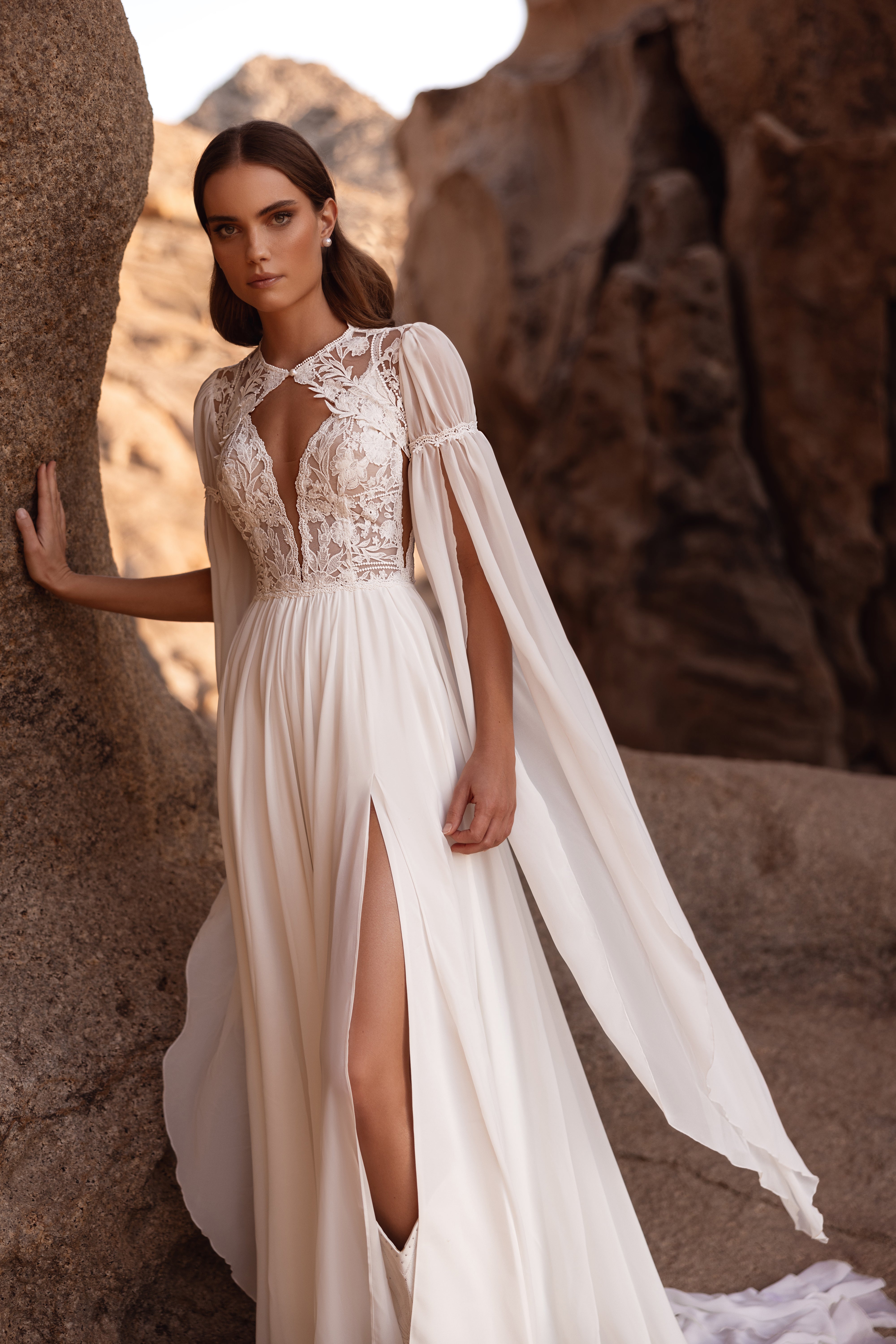 The back of the Etra wedding dress features intricate lace detailing and soft chiffon sleeves for a romantic, timeless look.