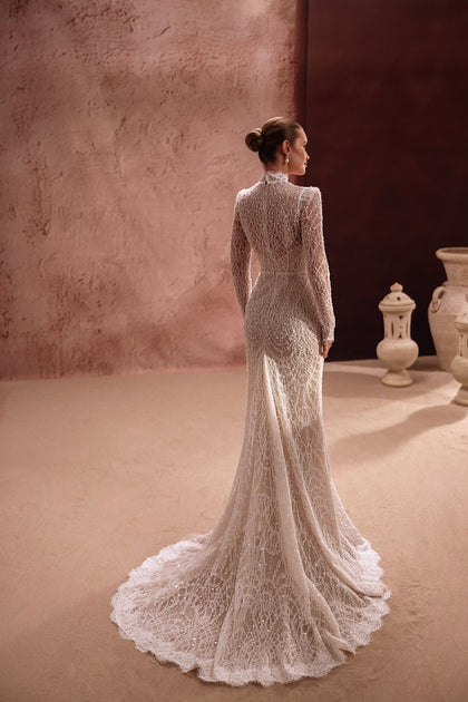 The Henriette bridal gown features a lace back and scalloped hem train, perfect for a timeless romantic look.