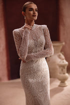 The Henriette bridal dress features a form-fitting lace silhouette with pearl detailing for graceful sophistication.