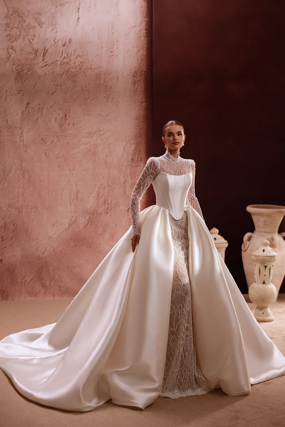The Henriette luxury wedding gown features a high neck lace top and voluminous satin skirt, perfect for a royal-inspired bride.