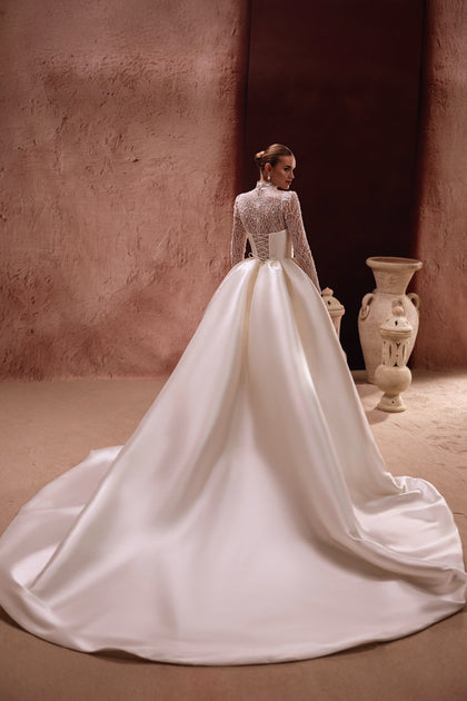 The back view of the Henriette gown showcases a dramatic satin train and intricate lace bodice for a royal-inspired bridal look.