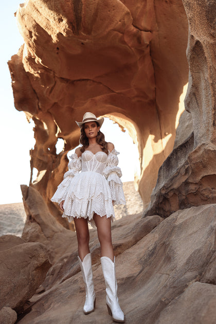 The Jolena bridal gown with embroidered puff sleeves and layered lace skirt captures effortless rustic boho elegance.