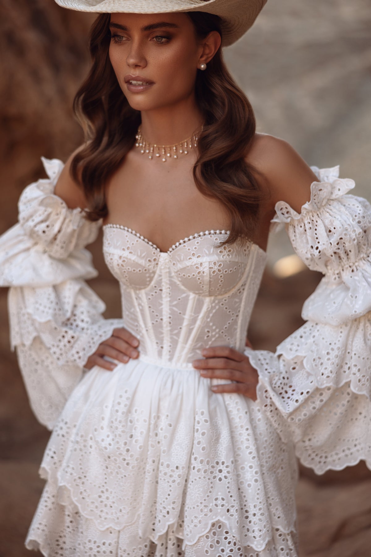 Close-up of Jolene wedding dress, with pearl-edged openwork lace and detachable puff sleeves