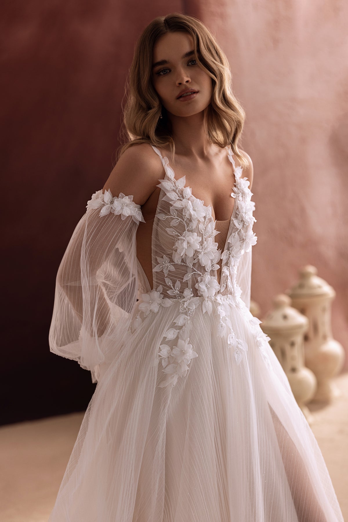 Lilibeth wedding dress from the front, with a deep V neckline and 3D flowers on the bodice