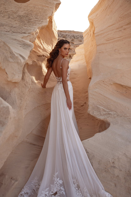 The Malika bridal gown combines an airy A-line silhouette with a beautifully open lace back.