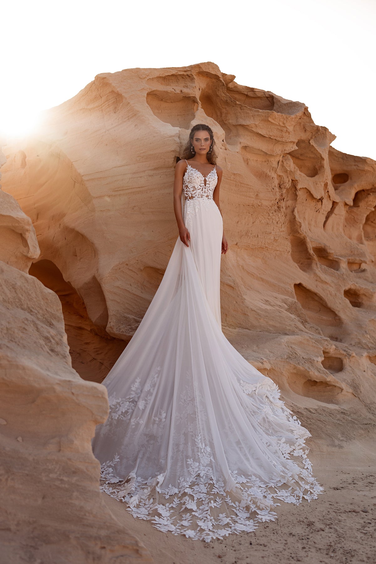 Full-length Malika A-line wedding dress in a sandstone gorge, with a flowing train
