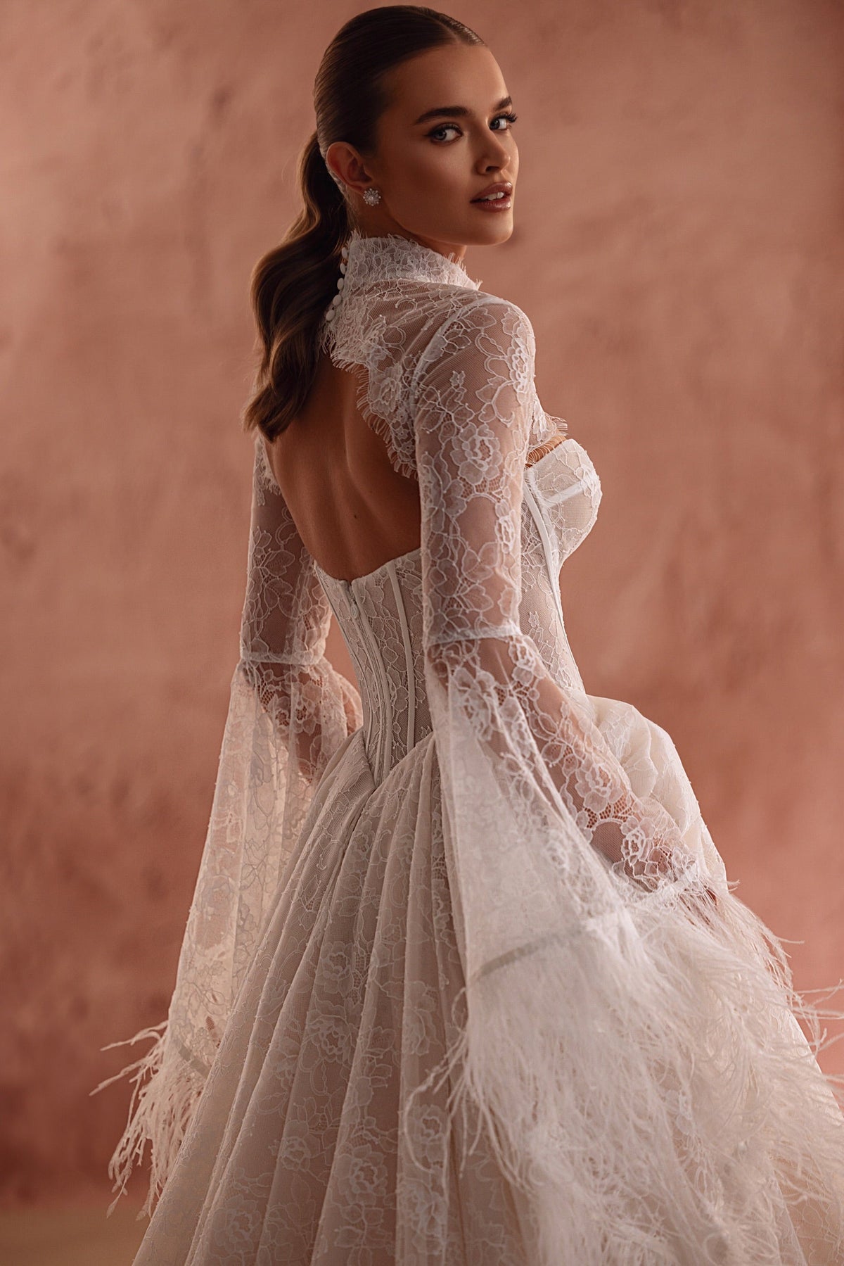 Michelle bolero from the back, with a high lace collar, open back and feather-trimmed sleeves