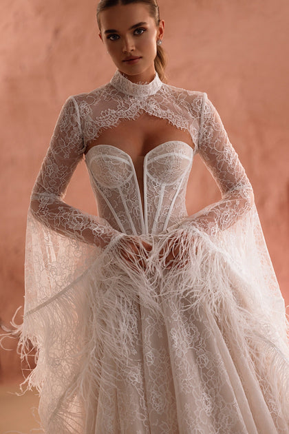 The Michelle bridal gown with an open lace back and feathered sleeves offers a romantic yet refined look.