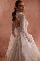 The Michelle lace wedding bolero with couture-inspired sleeves gives the bridal gown a distinctive flair.