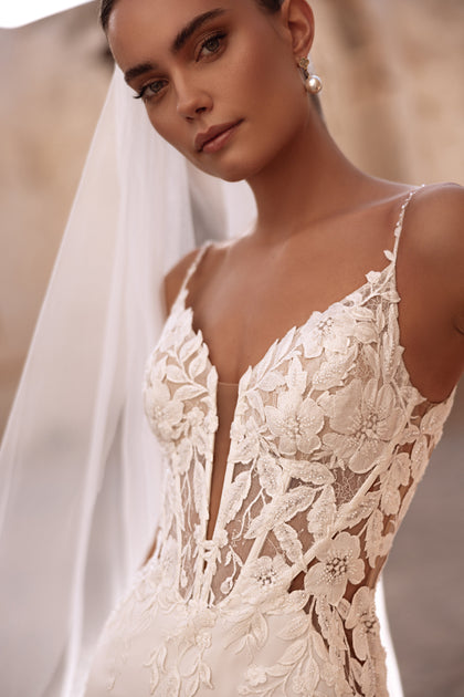 The Munira bridal dress with 3D lace embroidery and sheer details exudes elegance and contemporary femininity.