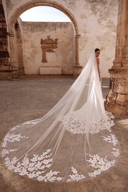 The Munira cathedral-length veil with embroidered floral edges delivers a majestic, glamorous bridal look.