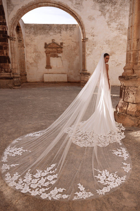 Munira chapel-length bridal veil with delicate floral lace, perfect for a romantic heritage wedding setting.