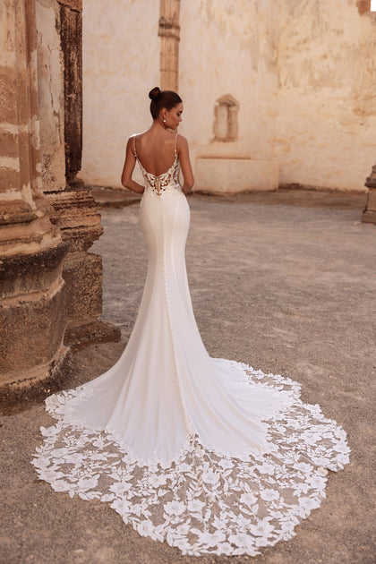The Munira bridal dress with a slim fit and lace-embellished train combines timeless sophistication and sensual grace.