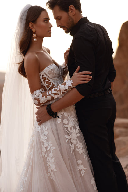 Nabila bridal veil with soft floral accents, enhancing a lace-sleeved wedding dress for an elegant look.