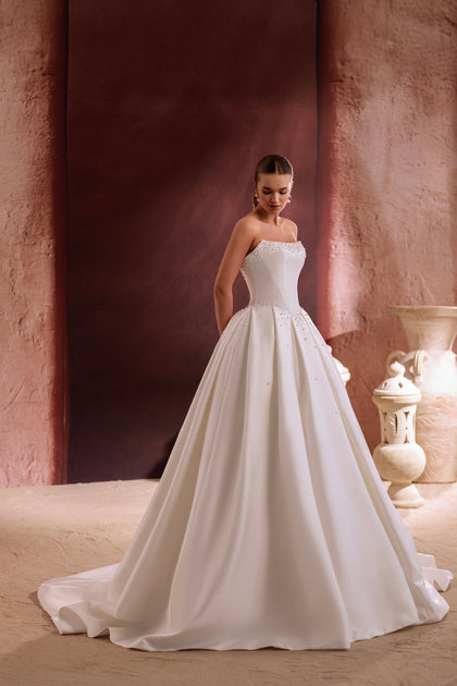 The Noor bridal gown featuring pearl beading and a classic ball gown silhouette exudes grace and sophistication.