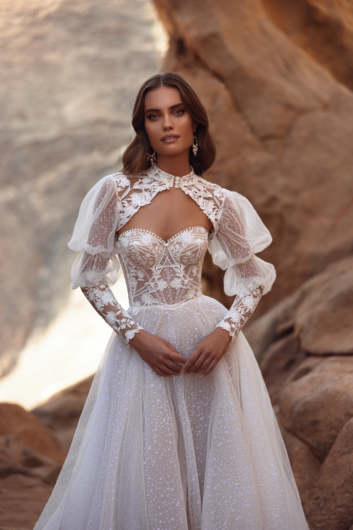 Oasis wedding dress with a high-necked lace bolero over the sheer corset