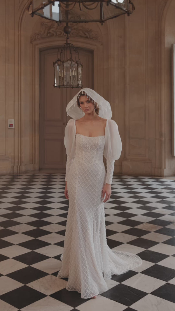 Video of the Chanin wedding dress – a clean strapless neckline and beaded fitted silhouette.