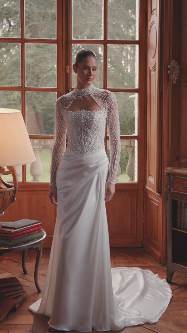 Video of the Greta wedding dress in motion – mermaid silhouette with a richly beaded strapless corset and draped satin skirt.