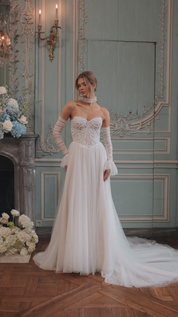 Video of the Dothea wedding dress in motion – A-line silhouette with a sculpted strapless bodice traced with luminous detail.