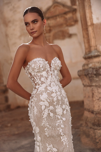 The Sarifa lace bridal gown featuring a long chapel train offers opulent elegance and refined silhouette.
