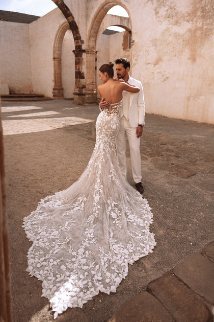 The Sarifa fishtail bridal gown with lace embroidery and structured corset defines timeless feminine grace.