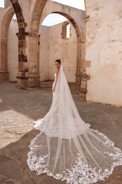 The Sarifa Veil long cathedral wedding veil with lace edging perfectly complements a romantic bridal look.