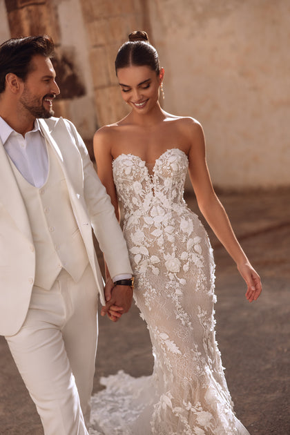 The Sarifa wedding gown with open back and floral lace train beautifully combines elegance and sensuality.