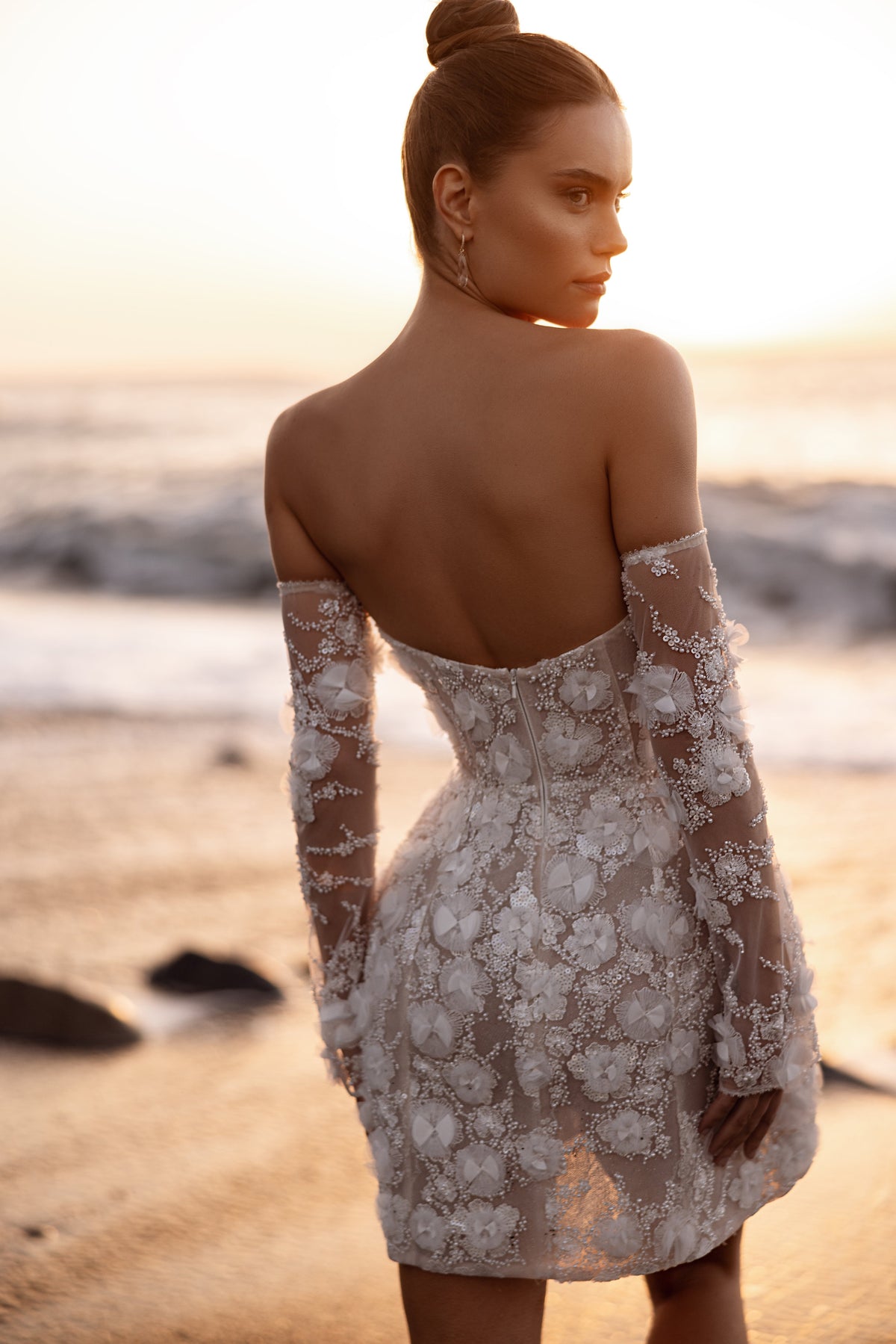 Rear close-up of Kayla short wedding dress, showing the open back and long lace sleeves