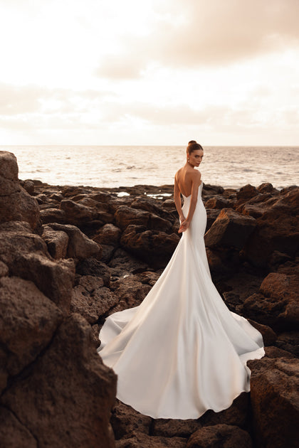 The Soraya strapless bridal dress highlights the waistline with a refined silhouette and subtle satin sheen.