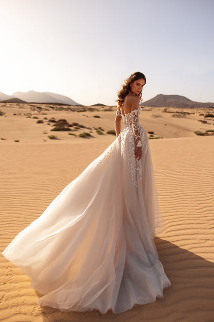 The Tamara bridal gown featuring long lace off-shoulder sleeves evokes refined feminine beauty.
