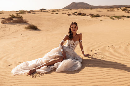 The Tamara mini bridal gown with detachable tulle skirt embodies contemporary elegance with a daring twist.