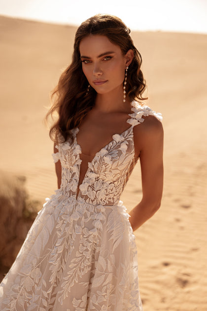 The Wisteria bridal gown with plunging V-neck and floral lace highlights feminine elegance.