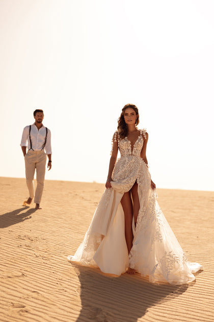 The Wisteria wedding dress with skirt slit combines contemporary style with classic elegance.