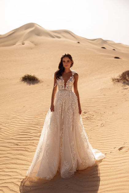 The Wisteria princess bridal gown with lace corset and floral appliqués exudes fairy-tale charm.